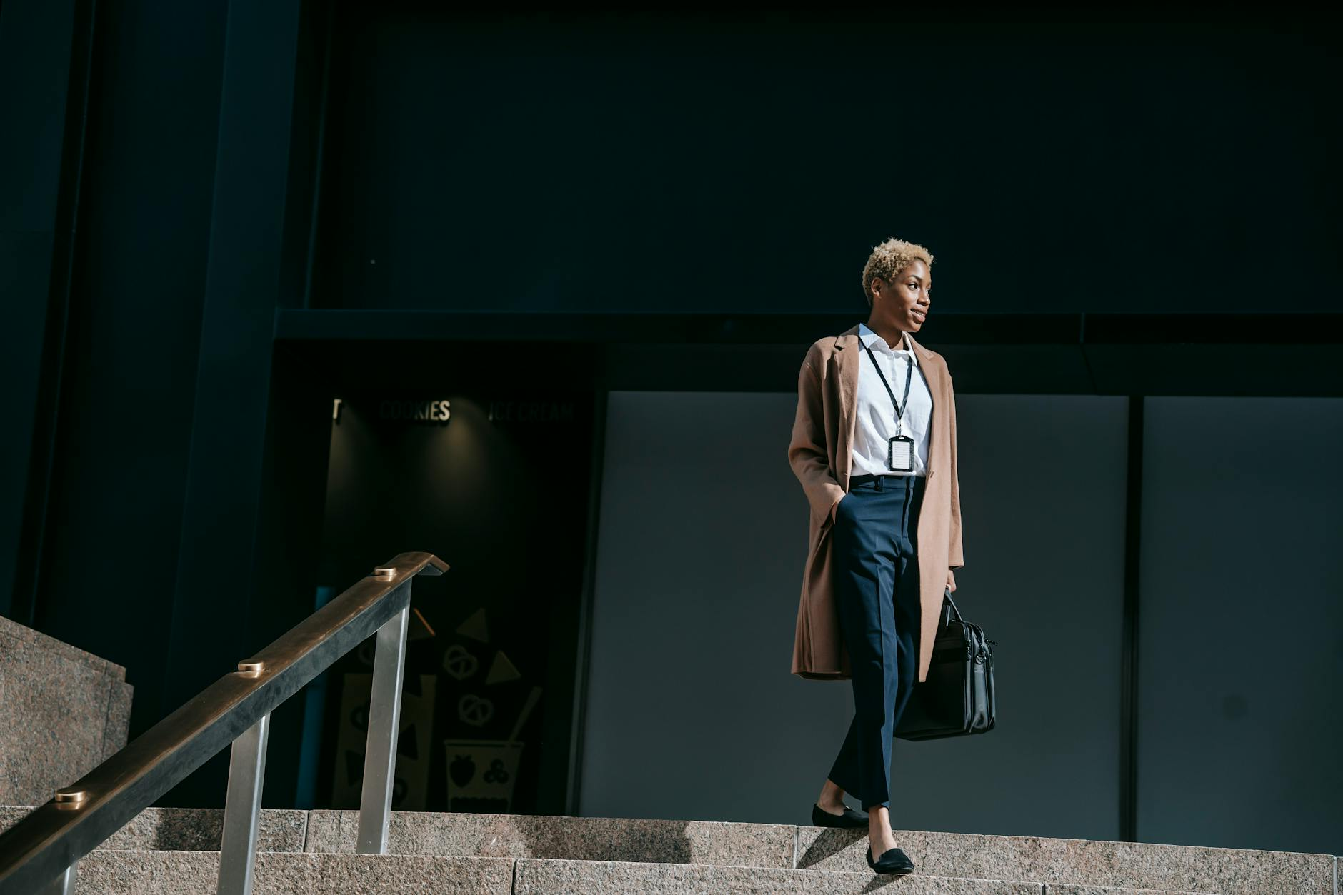 smiling ethnic businesswoman on stairs