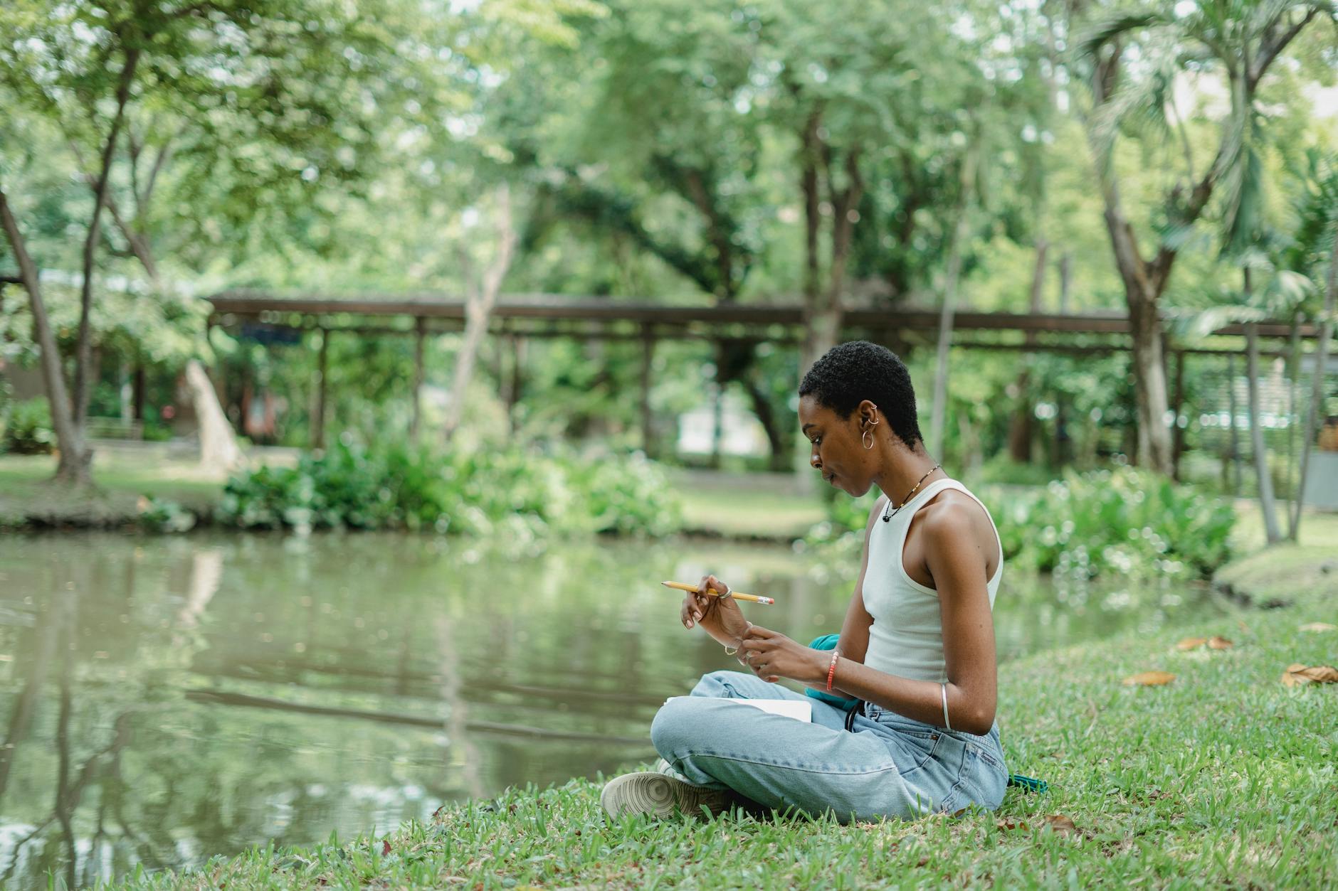 woman sitting by the lake